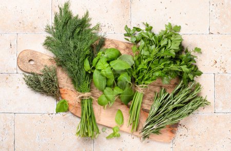 Photo for Various garden herbs on cutting board. Basil, dill, parsley, rosemary. Flat lay - Royalty Free Image