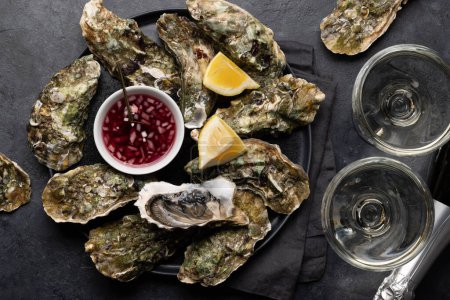 Photo for Fresh oysters with glasses of sparkling wine. Flat lay - Royalty Free Image
