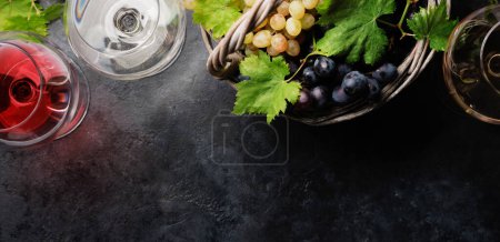 Foto de White, rose and red wine glasses and grape in basket. Flat lay with copy space - Imagen libre de derechos