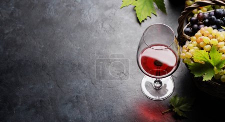 Photo for Glass of red wine and grape in basket. With copy space - Royalty Free Image