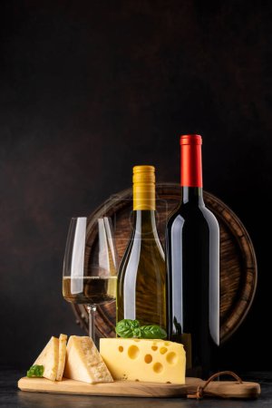 Photo for Various cheese on board, red and white wine. With copy space - Royalty Free Image