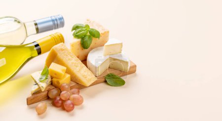 Photo for Various cheese on board and white wine. With copy space - Royalty Free Image