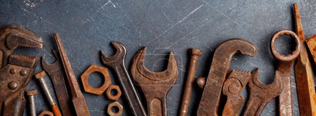 Photo for Vintage old rusty tools on stone backdrop. Top view flat lay - Royalty Free Image