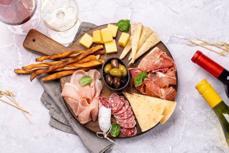 Photo for Antipasto board with various meat and cheese snacks. Flat lay - Royalty Free Image