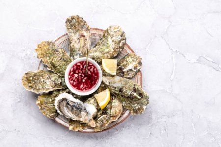 Photo for Fresh oysters with sauce and lemons. Flat lay with copy space - Royalty Free Image
