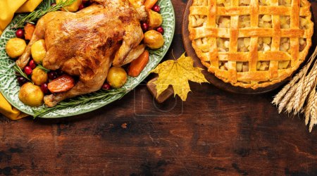 Foto de Thanksgiving turkey and apple pie on rustic table with copy space. Flat lay - Imagen libre de derechos