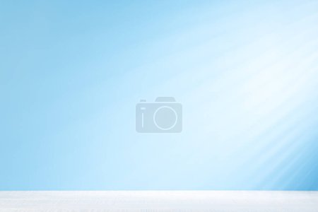 Photo for White table mockup with jalousie shadows on the blue wall - Royalty Free Image