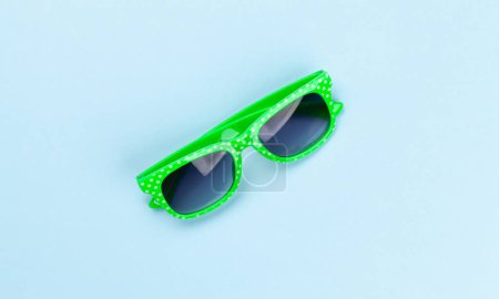 Photo for Sunglasses on blue background. Flat lay - Royalty Free Image