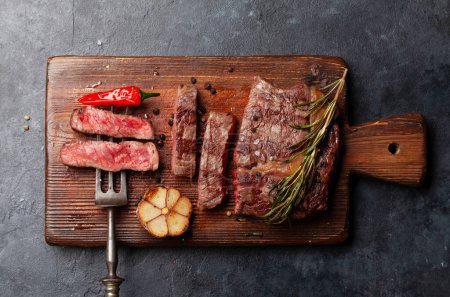 Photo for Grilled ribeye beef steak with herbs and spices. Flat lay - Royalty Free Image