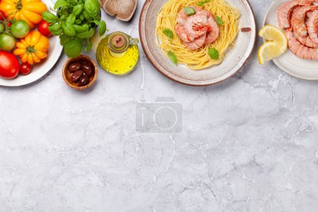 Photo for Pasta with shrimps and various garden tomatoes. Italian cuisine. Flat lay with copy space - Royalty Free Image
