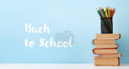 Photo for Old books and colorful pencils on wooden table and copy space. School and education template - Royalty Free Image