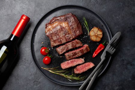 Téléchargez les photos : Bifteck de bœuf côtelé grillé aux herbes et épices. Pose plate - en image libre de droit