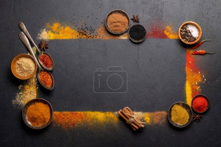 Foto de Various spices on stone table. Frame with copy space for your menu or recipe - Imagen libre de derechos