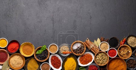 Photo pour Various spices in bowls on stone table. With copy space for your menu or recipe - image libre de droit
