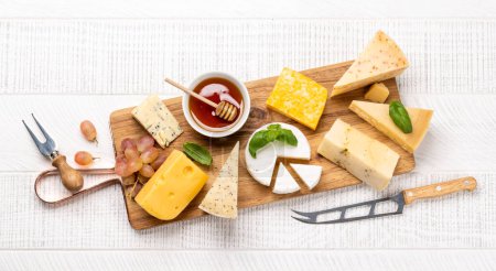 Photo for Various cheese on wooden board. Flat lay with copy space - Royalty Free Image