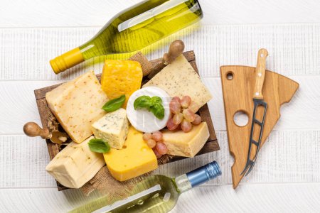 Photo for Various cheese in box and white wine. Flat lay - Royalty Free Image