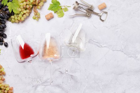 Photo for White, rose and red wine glasses and grape. Flat lay with copy space - Royalty Free Image