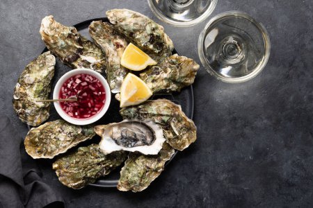 Photo for Fresh oysters with glasses of sparkling wine. Flat lay with copy space - Royalty Free Image