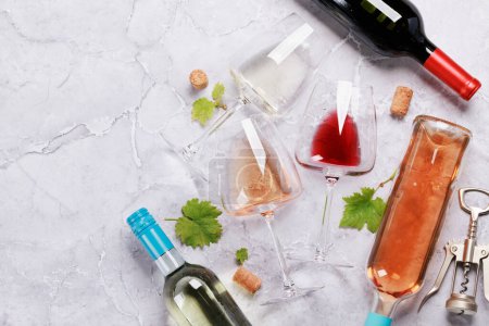 Photo for White, rose and red wine glasses and bottles. Flat lay with copy space - Royalty Free Image