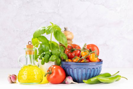 Photo for Ingredients for cooking. Italian cuisine. Tomatoes, olive oil, basil. With copy space - Royalty Free Image