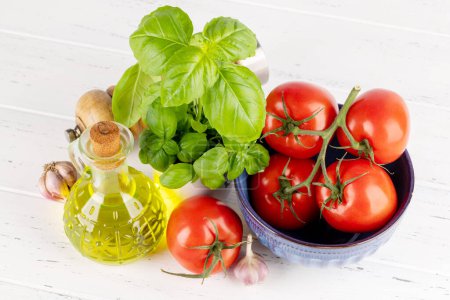Foto de Ingredients for cooking. Italian cuisine. Tomatoes, olive oil, basil - Imagen libre de derechos