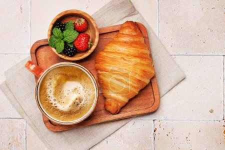 Photo for Coffee cup, berries and croissant. Flat lay with copy space - Royalty Free Image