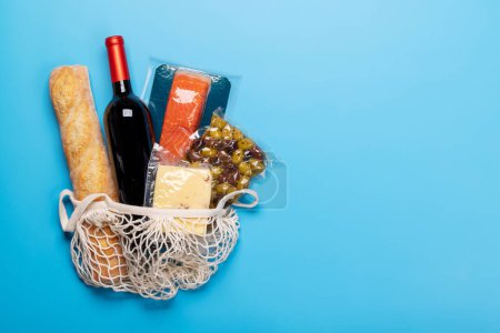 Photo for Shopping bag with wine and food. Flat lay with copy space - Royalty Free Image