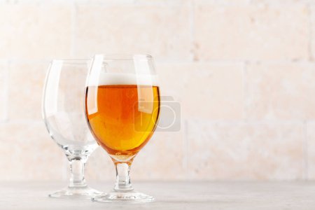 Photo for Two beer glasses. Empty and full. With copy space - Royalty Free Image