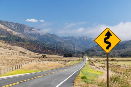 Photo for Asphalt road, road sign and country landscape with sunny sky. California State Route One - Royalty Free Image
