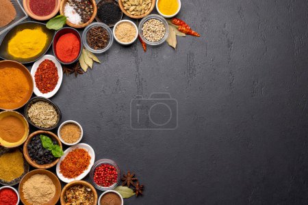 Téléchargez les photos : Various spices in bowls on stone table. With copy space for your menu or recipe - en image libre de droit