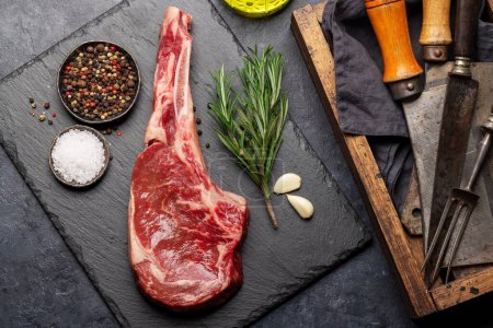 Photo for Raw Tomahawk beef steak and spices. Ready for grilling. Flat lay - Royalty Free Image