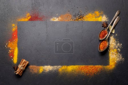 Photo for Various spices on stone table. Frame with copy space for your menu or recipe - Royalty Free Image