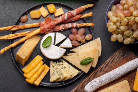 Téléchargez les photos : Antipasto board with various cheese and snacks. Flat lay - en image libre de droit