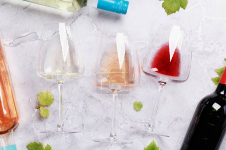 Photo for White, rose and red wine glasses and bottles. Flat lay - Royalty Free Image