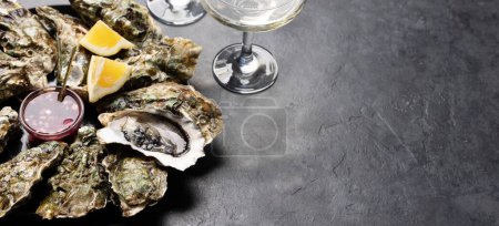 Téléchargez les photos : Fresh oysters with glasses of sparkling wine. With copy space - en image libre de droit