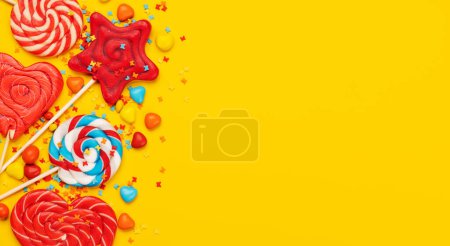 Photo for Various candy sweets on yellow background and copy space for your text. Flat lay - Royalty Free Image