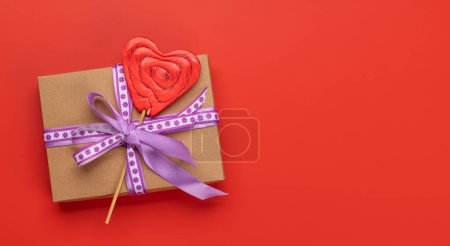 Photo for Gift box and candy heart lollipop and space for your greetings. Valentines day. Flat lay - Royalty Free Image
