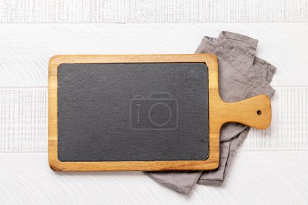 Photo for Wooden cutting board and kitchen towel. Flat lay with copy space - Royalty Free Image