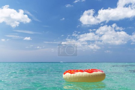 Photo for Inflatable donut ring in sea. Summer vacation - Royalty Free Image