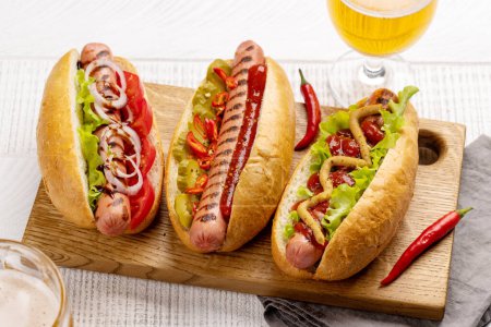 Photo for Various hot dog and beer. Homemade hotdogs on cutting board - Royalty Free Image