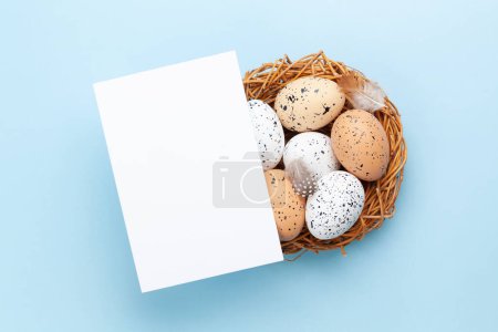 Photo for Easter greeting card over easter eggs in nest. Top view flat lay with copy space - Royalty Free Image
