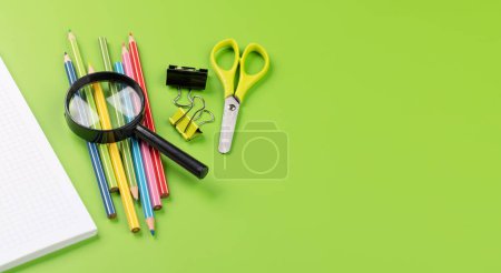 Photo for School supplies and stationery on green background. With blank space - Royalty Free Image