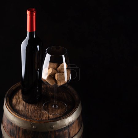 Photo for Red wine bottle, barrel and wine glass with corks. With blank space for your text - Royalty Free Image