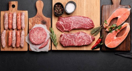 Photo for Various raw meat and fish. Steaks, sausages, salmon and spices. Flat lay - Royalty Free Image