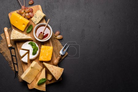 Photo for Various cheese on wooden board. Flat lay with copy space - Royalty Free Image