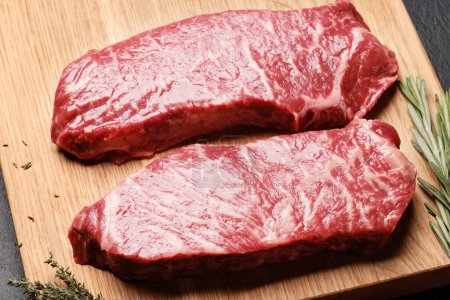 Photo for Prime marbled beef steaks. Raw sirloin steak on cutting board - Royalty Free Image