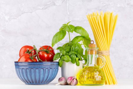 Photo for Ingredients for cooking. Italian cuisine. Pasta, tomatoes, basil - Royalty Free Image