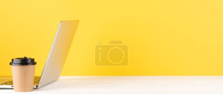 Photo for Laptop and coffee cup on wooden table. Computer on desk with blank space for your text - Royalty Free Image