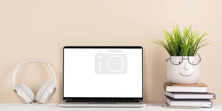 Photo for Laptop with blank screen for your message, app or web and potted plant. Computer with white display - Royalty Free Image