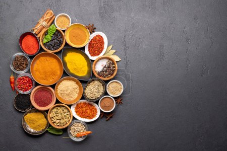 Téléchargez les photos : Various spices in bowls on stone table. With copy space for your menu or recipe - en image libre de droit